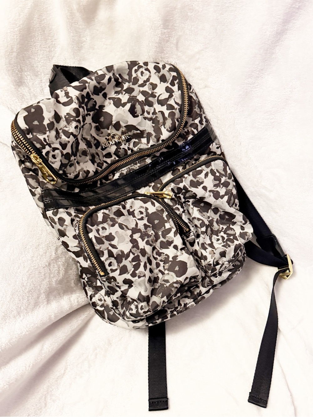 Retired Kipling medium backpack in a multicolored grey with patent leather